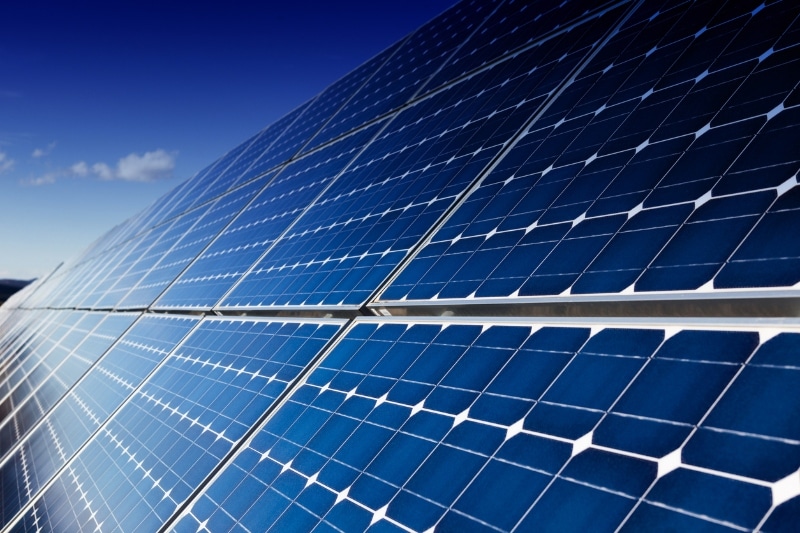 Photovoltaic solar panels installation and blue sky with few clouds